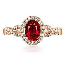 a ring with a red stone surrounded by diamonds