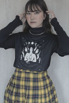 get ready to be 𝖔𝖇𝖘𝖊𝖘𝖘𝖊𝖉 with this Hekate shirt ☠︎︎ it's the perfect cozy alt tee to worship our goddess of witchcraft in or just to make any outfit ~ ✮ 𝖆𝖊𝖘𝖙𝖍𝖊𝖙𝖎𝖈 ✮ ~ 🕯🔮 🖤 𝖕𝖗𝖔𝖉𝖚𝖈𝖙 𝖎𝖓𝖋𝖔  ♡ Gildan 5000 Tshirt (Bella Canvas & Comfort Colors brand shirts available upon request + additional cost) ♡ 100% cotton, medium-weight fabric ♡ Comfy, relaxed unisex fit 🕯🔮 🖤 𝖘𝖎𝖟𝖎𝖓𝖌  ♡ Runs true to size, classic unisex fit ♡ Size up 2 sizes for an oversized look ♡ Swipe ➸ through product photos for Size Guide & measurements 🕯🔮 🖤 𝖘𝖍𝖎𝖕𝖕𝖎𝖓𝖌 𝖎𝖓𝖋𝖔  ♡ Processing time = 1-7 days ♡ Shipping time = 3-5 days ♡ Our items are individually made with love for each of our buyers. Because of this, our processing time is 1-7 business days (depending on order volume) pl Black Goblincore Tops For Halloween, Black Witchy Tops With Letter Print, Fairy Grunge Cotton Tops For Fall, Cotton Top With Moon Print For Fall, Black Goblincore Tops For Fall, Alternative Style Tops With Screen Print For Fall, Cotton Tops With Moon Print For Fall, Goblincore Black Tops For Fall, Goblincore Long Sleeve Tops For Fall