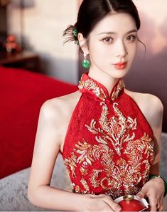 This elegant red halter Qipao Cheongsam dress is a stunning representation of traditional Chinese fashion with a modern twist. Adorned with intricate golden sequin flowers on the top, it exudes sophistication and grace. The high-neck, sleeveless design flatters the figure while the luxurious fabric and exquisite detailing create a perfect balance of beauty and tradition. Ideal outfit for Chinese weddings and tea ceremony. Size Guide: Please note Asian size runs small, please check our size chart Traditional Chinese Fashion, Sequin Flowers, Qipao Cheongsam, Chinese Fashion, Embroidery Gifts, Cheongsam Dress, Chinese Wedding, Elegant Red, Tea Ceremony