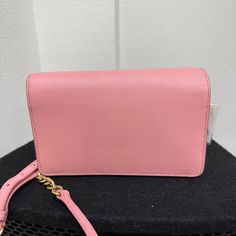 Expertly crafted in Italy, this Prada WOC is crafted from Vitello Move leather in pink. Its top flap with signature detailing opens to a lined interior. The bag comes with a gold-tone shoulder chain. Luxury Pink Wallet On Chain For Formal Occasions, Luxury Pink Wallet On Chain For Everyday Use, Luxury Pink Wallet On Chain, Elegant Pink Luxury Wallet On Chain, Luxury Pink Elegant Wallet On Chain, Prada Saffiano, Wallet On Chain, Shoulder Chain, Chain Bags