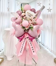 a bouquet of balloons and pink flowers in the shape of an eiffel tower