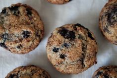 blueberry muffins are arranged on a white paper towel and ready to be eaten