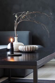 a table with a vase and candle on it