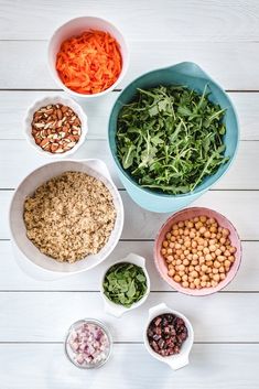 bowls filled with different types of food on top of a white wooden table next to each other