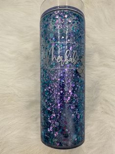 a purple and blue glittered tumbler with the words aloha on it