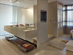 a bathroom with two sinks and a large mirror in it's center, next to a bathtub