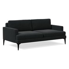 a black couch sitting on top of a white floor