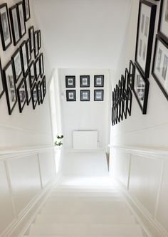 the hallway is decorated with black and white frames