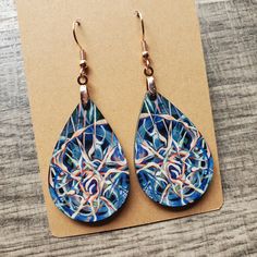 This pair of lightweight, teardrop earrings adds a unique touch, featuring original neuro-inspired artwork, "Cycle of Thought". They are artsy, vibrant and a creative way to advocate for healthy thought patterns. A unique accessory for anyone needing a gentle reminder, but also eye-catching jewelry for those in neuroscience, counseling or medical professions. "We have the power to reclaim our thought life through the simple practice of being aware of our every notion. Even the smallest thoughts can grow in influence to lead us into either a cycle of chaos and despair or life-giving peace and hope." If you are interested in the original artwork that inspired this item or seeing more from the art collection, visit Geinene.com or follow me on Instagram @Geinene .: Made from lightweight, MDF w Artsy Blue Teardrop Earrings, Unique Hypoallergenic Teardrop Earrings, Nickel-free Teardrop Artsy Earrings, Artistic Teardrop Earrings, Artistic Teardrop Earrings With Artistic Design, Artsy Teardrop Earrings With Ear Wire, Unique Hand Painted Teardrop Earrings, Adjustable Teardrop Artsy Earrings, Artistic Teardrop Earrings As Gift