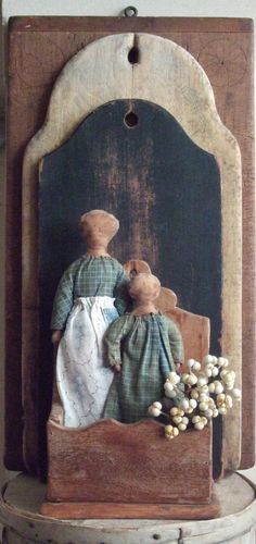 a couple of figurines sitting on top of a wooden table next to each other