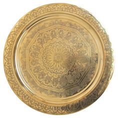 a gold plate with intricate designs on it