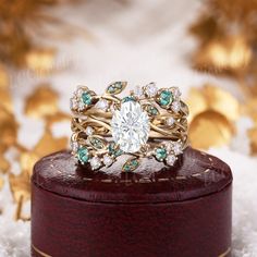 a close up of a ring on top of a wooden box with snow around it