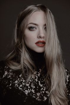 a woman with long blonde hair and red lipstick