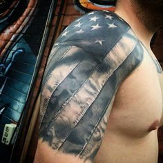 a man's arm with an american flag tattoo on it