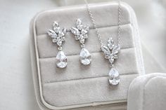 This delicate rose gold crystal drop wedding necklace set is a perfect, feminine finishing touch to any bridal look! A versatile and beautiful addition to your classic, modern, or vintage-inspired wedding.- PLEASE ALLOW APPROX 7 BUSINESS DAYS FOR COMPLETION BEFORE SHIPPING - Created with Premium Cubic Zirconia stones- Necklace measures 16" long and extends to 18 inches.- Matching earrings measure 1-5/8" x 5/8" - Available in rose gold, yellow gold and rhodium (silver) finishes This is an origina Elegant Sparkling Jewelry Sets For Wedding, Elegant Teardrop Bridal Necklace With Matching Earrings, Elegant Rose Gold Sterling Silver Jewelry Sets, Elegant Sterling Silver Drop Bridal Necklace, Silver Drop Jewelry Sets For Wedding, Elegant White Jewelry Sets For Bridesmaids, Rose Gold Sterling Silver Wedding Jewelry Sets, Rose Gold Sterling Silver Jewelry Sets For Wedding, Elegant Bridal Necklace With Matching Earrings