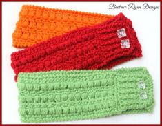 three crocheted headbands with buttons on each side, one red and one green