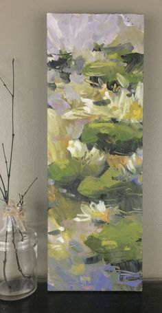 a painting on a wall next to a vase with flowers