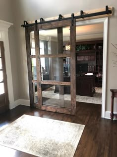 a living room with sliding glass doors and hardwood floors