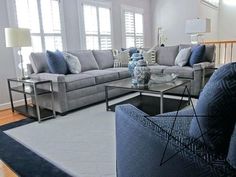 a living room filled with furniture and windows