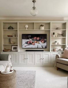 a living room filled with furniture and a flat screen tv