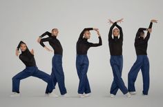 a group of people in black shirts and blue pants are doing different poses with their hands up