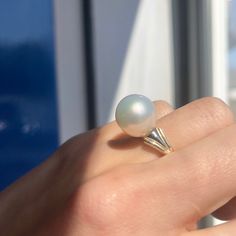 Two-tone 14KT white gold + yellow gold band ring with genuine, cultured Paspaley South Sea Pearl. Choose your finger size Contact us for additional sizes 12mm Paspaley Pearl; "Fine" quality; "Circle" shape Paspaley Certificate of Authenticity included Weight: 6.31g Made to order: please allow 7-10 business days prior to shipping Pearl will vary slightly from photos White Solitaire Pearl Ring Fine Jewelry, Timeless White Pearl Ring, Fine Jewelry White Pearl Ring With Round Band, White Pearl Ring With Round Band, White Pearl Ring Fine Jewelry, White Round Pearl Ring With Polished Finish, White Pearl Ring With Polished Finish, White Polished Pearl Ring, White Dome Ring Fine Jewelry