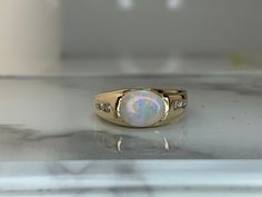 14kt yellow gold ring set with a genuine 9x7mm Ethiopian Opal and accented with diamonds! Weighs 3.8dwt and is currently a size 7 but can be resized! Unique Ethiopian Opal Ring, Luxury Handmade Ethiopian Opal Ring, Gold Ethiopian Opal Ring With Oval Cabochon, Gold Ethiopian Opal Cabochon Ring, Elegant Ethiopian Opal Ring, Hallmarked, Opal And Diamond Ring, Gold Ring Sets, Yellow Gold Ring, Ethiopian Opal