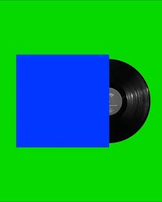 a black vinyl record on a green background with blue rectangles in the center