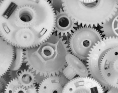 black and white photograph of many different gears