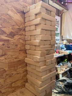 a large stack of wooden blocks sitting on top of a table next to a wall