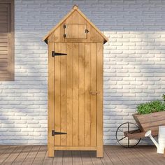 a wooden shed sitting on top of a wooden floor next to a white brick wall