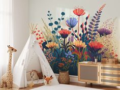 a child's room with a teepee tent, giraffe and flowers painted on the wall