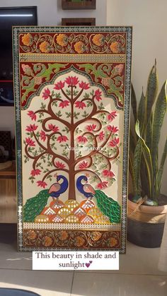 an intricately decorated painting with peacocks on it