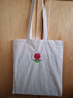 a white bag with a red house on it