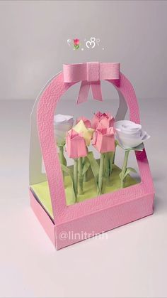 a pink and white box with flowers inside