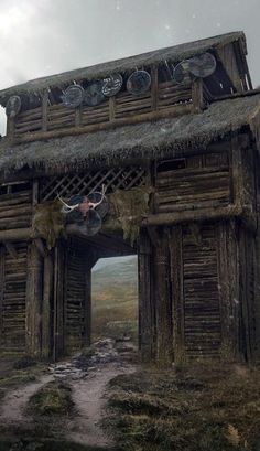 an old wooden building with a cow on the roof