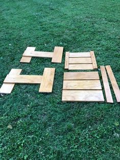 several pieces of wood laid out on the grass