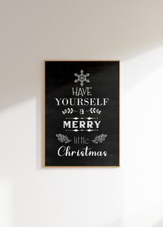 a black and white sign that says have yourself merry little christmas written on the wall