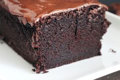 a piece of chocolate cake sitting on top of a white plate