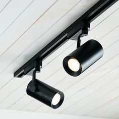 two spotlights are attached to the ceiling