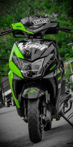 a green and black motorcycle parked on the street