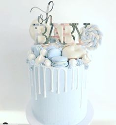 a blue and white cake with the words baby on it