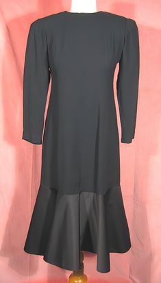 "Dramatic 70's cocktail dress in black crepe and satin by Estevez, who was the youngest designer to win the Coty award. Beautifully made, it's completely lined, and about a size 6. It measures approx. 14\" across slightly padded shoulders, up to 37\" bust, 20 1/2\" outside sleeve length, 28\" waist, 38\" hips, and 43\" overall length. It's in excellent, like new, condition. See my entire shop collection here https://www.etsy.com/shop/RobinClaytonVintage" Black Formal Midi Dress With Bias Cut, Black Knee-length Vintage Evening Dress, Black Knee-length Vintage Dress For Evening, Formal Black Bias Cut Midi Dress, Black Bias Cut Midi Dress For Formal Occasions, Fitted Black Vintage Cocktail Dress, Black Fitted Vintage Dress For Cocktail, Fitted Black Vintage Dress For Cocktail, Black Fitted Cocktail Vintage Dress