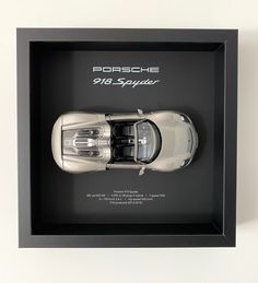 the porsche 918 spyder is in a black shadow box with white lettering on it