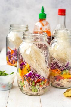 three jars filled with food sitting on top of a table