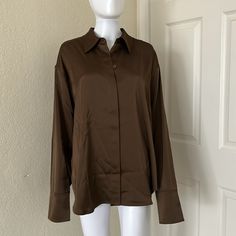 A True Oversized Fit, This Is Bound To Be Your New Favorite Button Down. Smooth Satin Fabric That Is Lightweight And Moves With Your Body. Exaggerated Cuffs Button Closure Lightmocha 95% Polyester 5% Elastane Smoke Free Home Ships Same/Next Day Oversized Brown Shirt For Spring, Brown Relaxed Fit Long Sleeve Blouse, Oversized Brown Shirt For Workwear, Oversized Brown Tops For Work, Oversized Brown Shirt With Button Closure, Office Brown Top With Button Cuffs, Brown Office Tops With Button Cuffs, Office Brown Tops With Button Cuffs, Office-appropriate Brown Tops With Button Cuffs