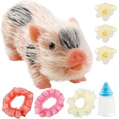 a small toy pig with hair on it's head and various accessories around it