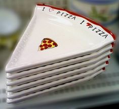 a stack of pizza plates sitting on top of a table