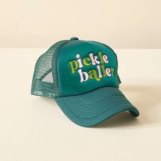 Get ready to serve some serious style with our Pickleballer Trucker Hat. Featuring trendy phrases and cute embroidered lettering, this lightweight hat is perfect for creating an effortless, on-trend look. Whether you're on the court or just on the go, this hat is the perfect way to top off your outfit. Key Features: Mesh back with adjustable snapback Embroidered letters Lightweight + Comfortable Includes: 1 trucker hat Green Baseball Cap For Summer Sports Events, Green Hat With Letter Print And Curved Bill, Green Curved Bill Hat With Letter Print, Trendy Adjustable Sports Hat, Green Trucker Hat For Spring Sports, Spring Green Trucker Hat For Sports, Green Trucker Hat For Sports In Spring, Green Visor Hat With Letter Print, Adjustable Novelty Sports Hats