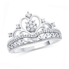 Treat her like royalty with this shimmering diamond ring. Crafted in cool 10K white gold, this beautifully detailed design features a round diamond composite at its center, diamond accents and a diamond chevron ribbon. Scrolling details create the heart-shaped crown and band. Captivating with 1/5 ct. t.w. of diamonds and a brilliant buffed luster, this crown ring reminds her of your love. Crown-shaped Diamond Ring With Diamond Accents, Crown-shaped Diamond Ring With Accents, Crown Shaped Diamond Ring With Diamond Accents, Crown Shape Diamond Ring With Accents, Anniversary Crown Diamond Ring In White Gold, Crown Shaped Diamond Ring Fine Jewelry, Anniversary Crown-shaped Diamond Ring With Accents, Fine Jewelry Crown Shaped Diamond Ring, Crown Shaped Diamond Ring For Anniversary